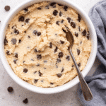 How to Make Cottage Cheese Cookie Dough That Tastes Amazing 6 Bowl of creamy cottage cheese cookie dough with chocolate chips and a spoon, perfect for a high-protein no-bake treat