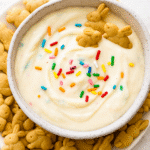 TikTok’s Viral High Protein Dunkaroo Dip You’ll Love 6 Bowl of creamy high protein Dunkaroo dip topped with rainbow sprinkles and served with bunny graham cracker cookies