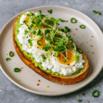 Avocado Cottage Cheese Toast: The High-Protein Breakfast Upgrade 6 Avocado cottage cheese toast with boiled egg and fresh greens on sourdough bread, high-protein breakfast